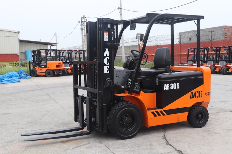 A bright orange forklift truck with black accents and the label 'AF 30 E' is parked on an outdoor concrete lot. In the background, there are multiple similar forklifts lined up, all featuring the 'ACE